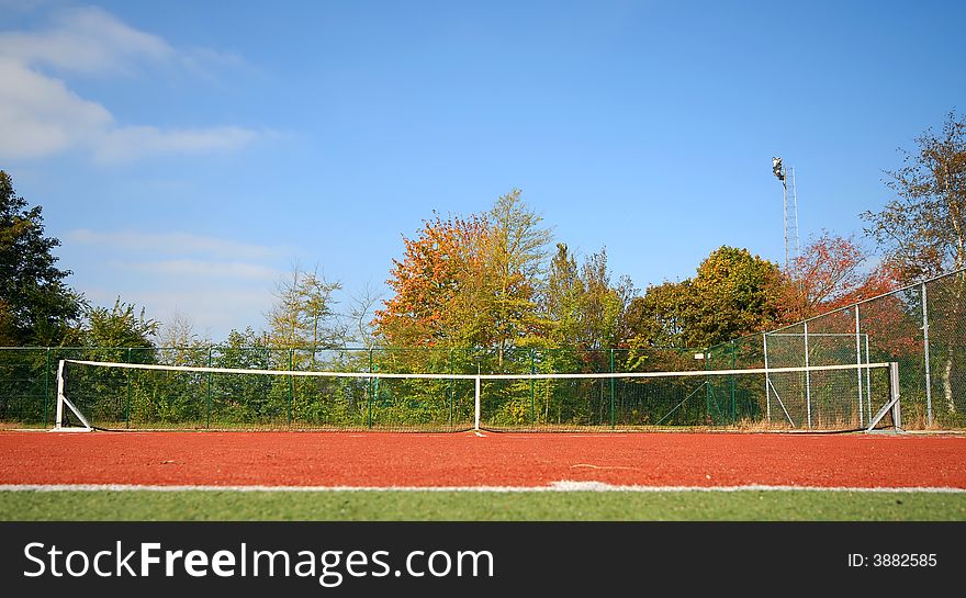 Tennis court under blue sky (wide angle)