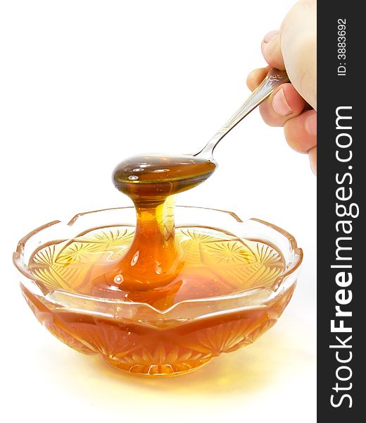 Honey in a crystal saucer isolated object on a white background with clipping path included