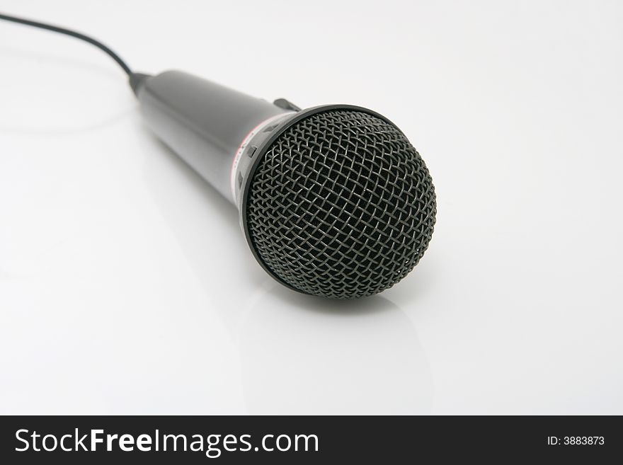 Black cylindrical microphone on a white background.