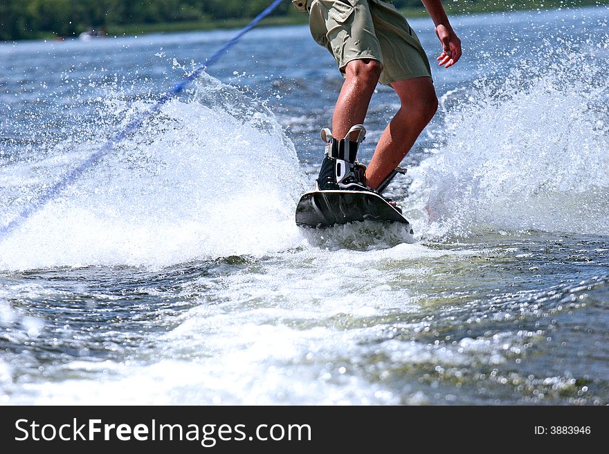 Young teen wakeboarding on the lake