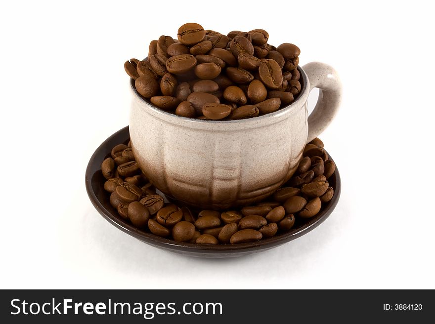 Coffee beans in the cup on white background