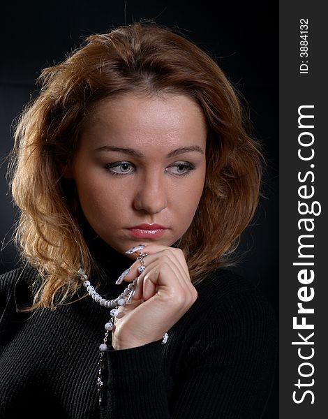 Cute redhead girl portrait on dark background