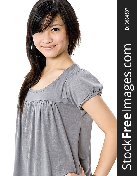 A cute young Asian woman in grey dress on white background. A cute young Asian woman in grey dress on white background