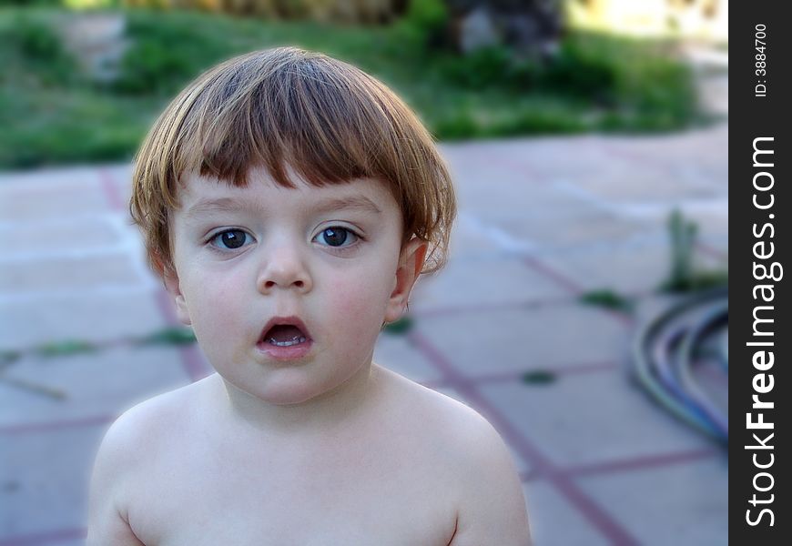 Young boy with dirty open mouth waiting for more ice cream. Young boy with dirty open mouth waiting for more ice cream