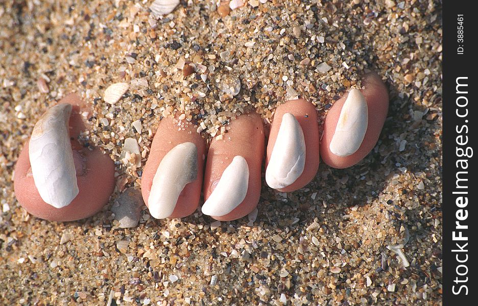 Sea sand and stones on toe-nails. Sea sand and stones on toe-nails