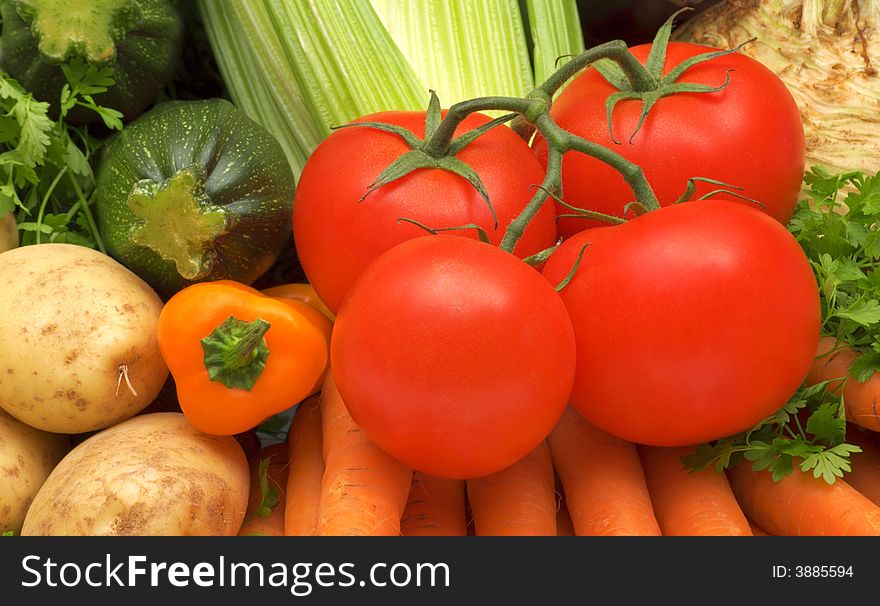 Fresh tomatoes on vegetables background