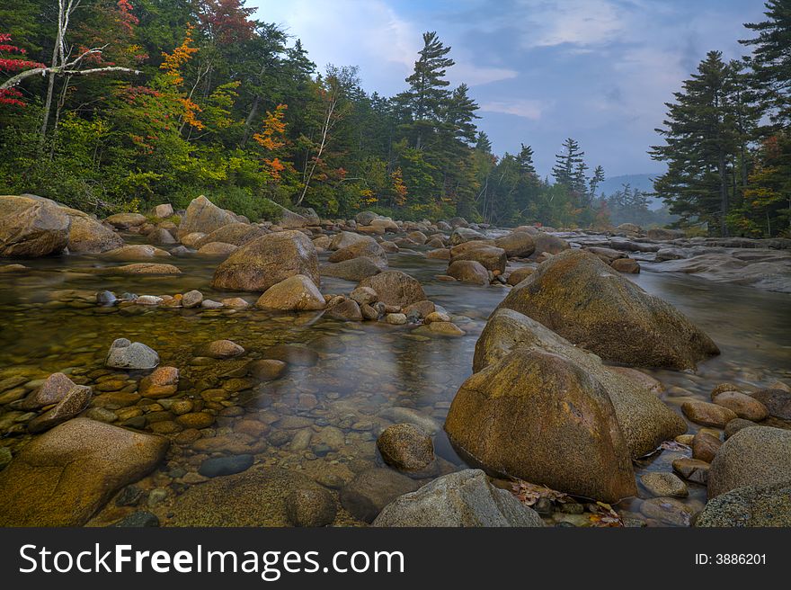 Autumn on Swift river in the white mountains of New Hampshire at dawn in the early autumn. Autumn on Swift river in the white mountains of New Hampshire at dawn in the early autumn