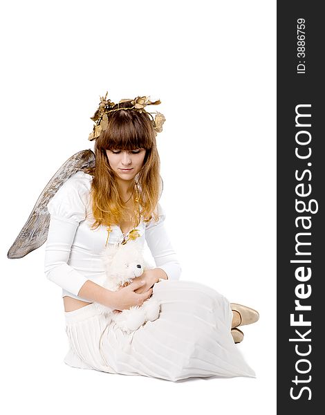 Angel girl sitting and holding teddy bear isolated on white. Angel girl sitting and holding teddy bear isolated on white