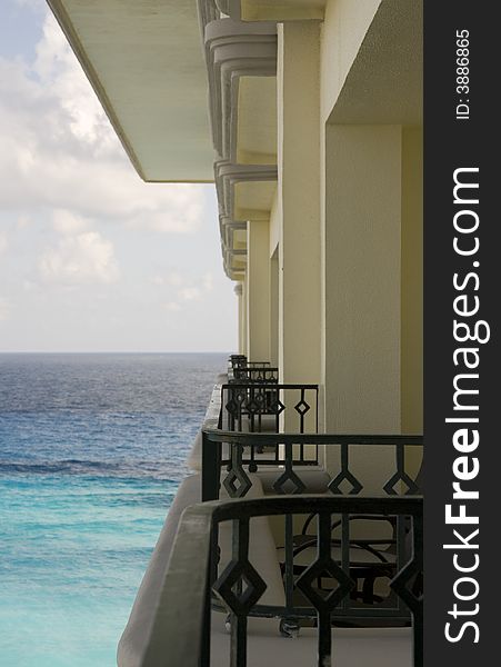 A row of balconies at a hotel descending out to sea. A row of balconies at a hotel descending out to sea