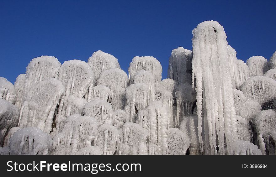 Icicles hanging at tree logs