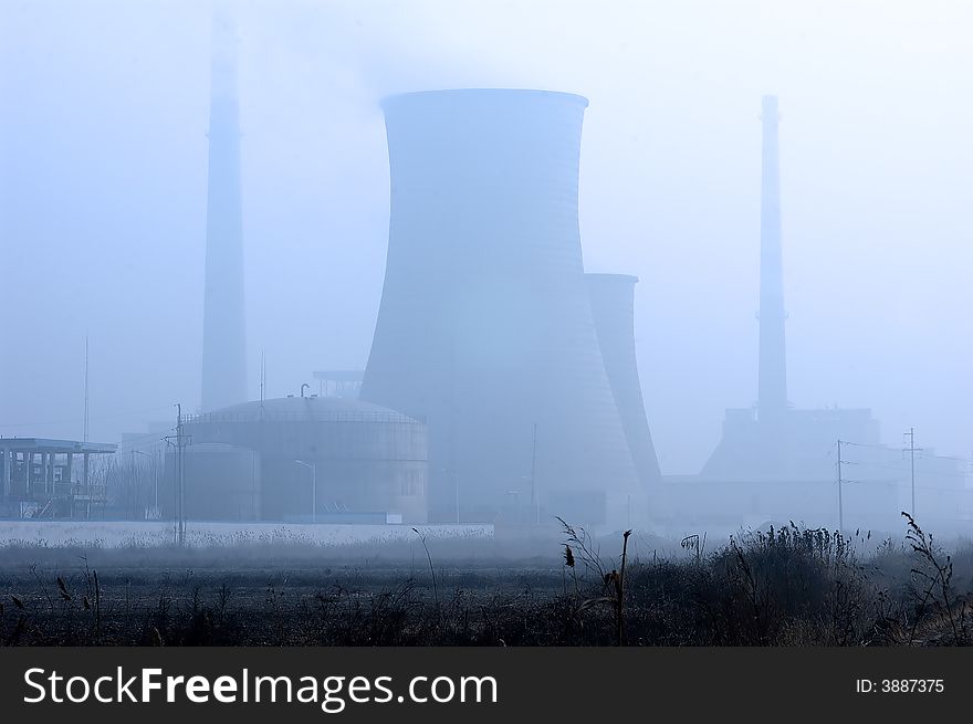 A factory's chimney in fog