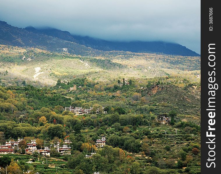 A village on mountain. The mountain is quite high and the cloud is covering the hill. This village is chosed as the most beautiful village of China.