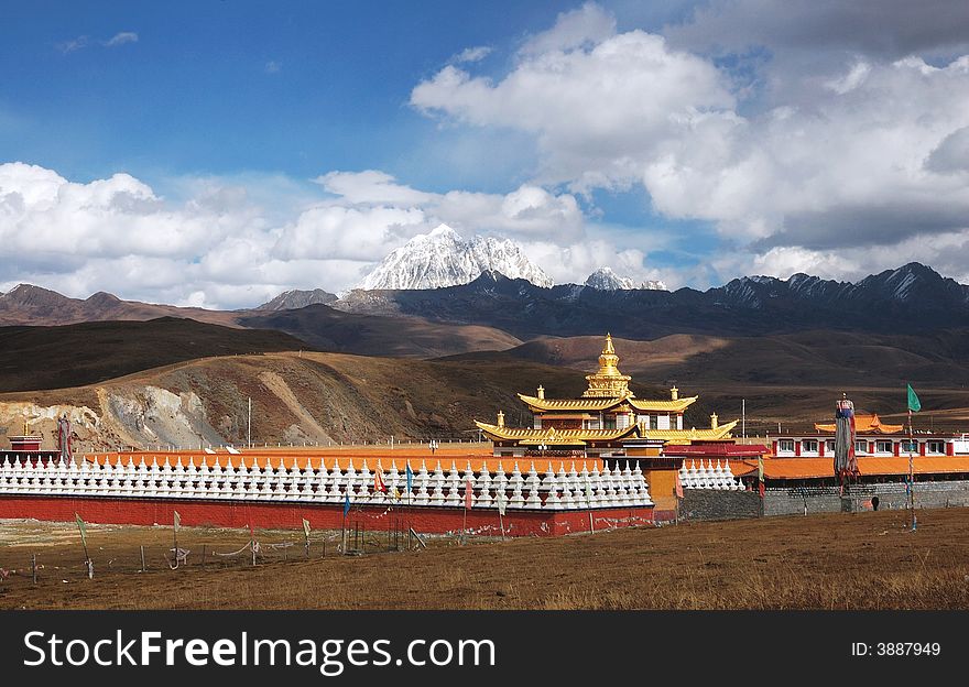 Jokul and Temple. A golden tower in a temple. The temple is at the foot of a Jokul.