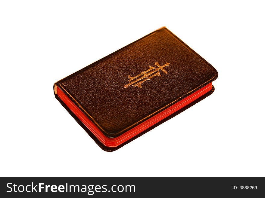 A black bible sits isolated on a white background.
