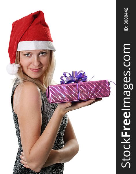 The young woman in red cap Santa with a gift in a hand. The young woman in red cap Santa with a gift in a hand