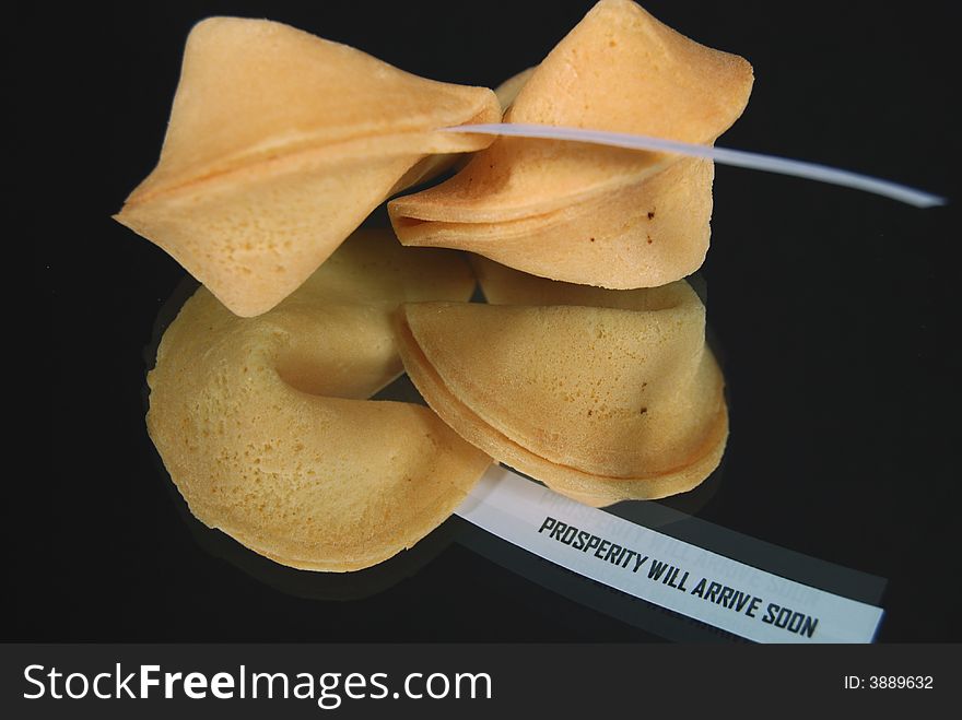 Pair of fortune cookies reflected on a mirror. Pair of fortune cookies reflected on a mirror.