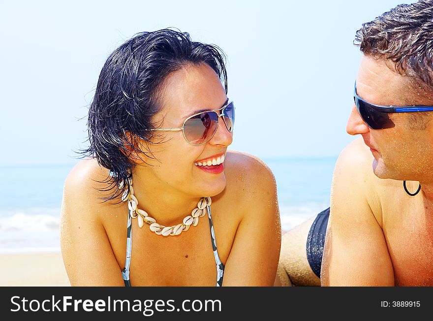 A portrait of attractive couple having fun on the beach. A portrait of attractive couple having fun on the beach.