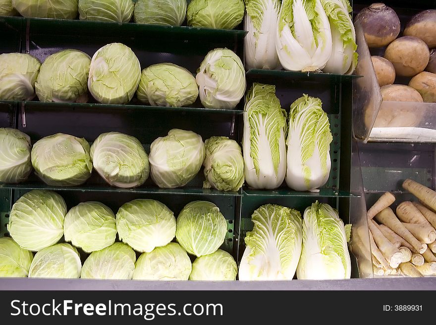 Grocery shelves full of cabbage and turnips