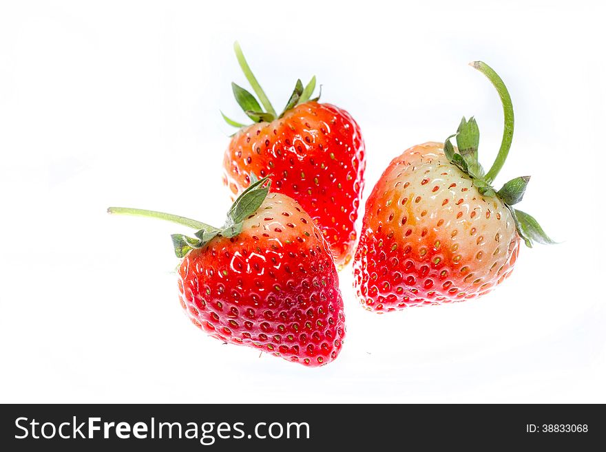 Close-up of fresh strawberries on white background