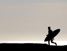 Surfer Running Along Cliff Stock Images