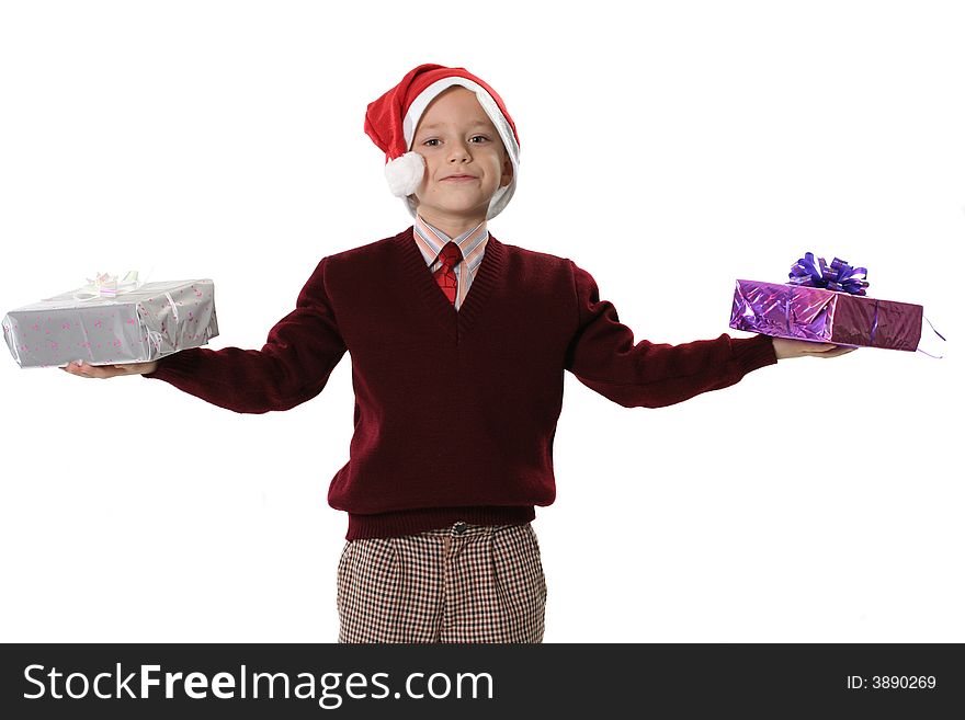 The boy in a sweater and cap Santa holds two gifts