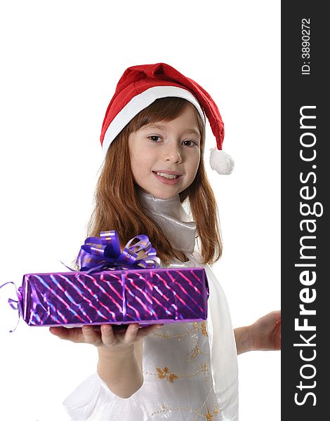 The girl in a white dress and cap Santa holds gift. The girl in a white dress and cap Santa holds gift