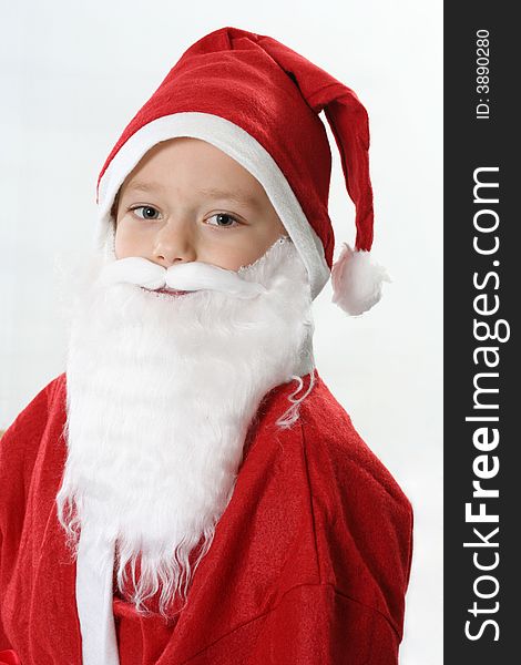 Portrait of a boy in cap Santa and white beard