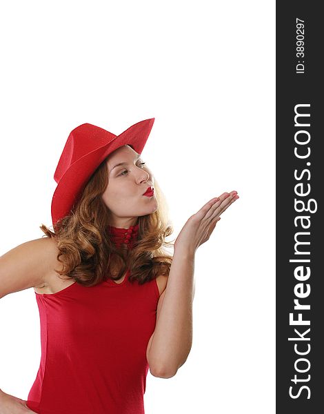 The girl in a red dress and a hat gives an air kiss