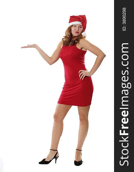 The attractive girl poses in a red dress and a hat Santa