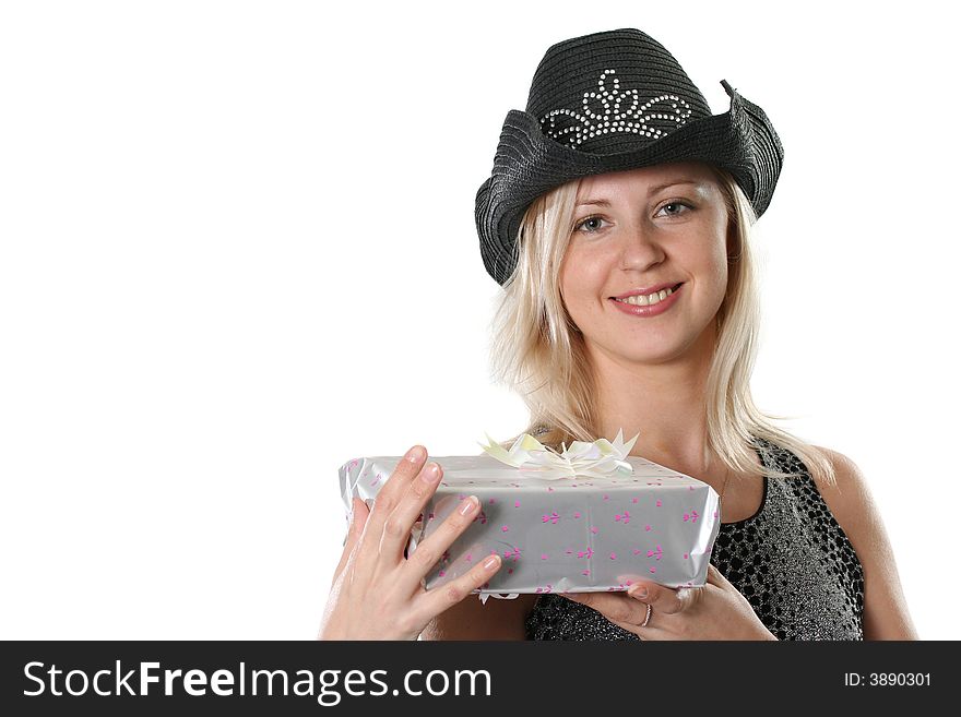 The beautiful young woman in a black hat with a gift. The beautiful young woman in a black hat with a gift