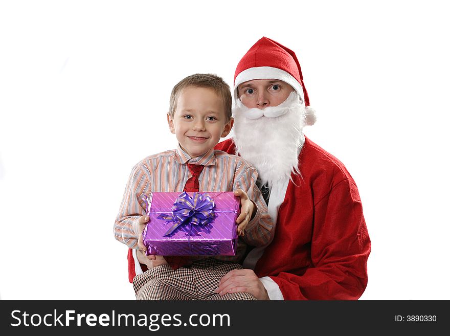 Santa poses with the little boy and a gift on a white background. Santa poses with the little boy and a gift on a white background