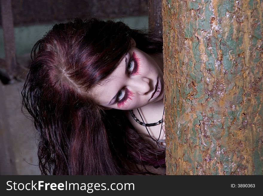 The woman-vampire looks because of a rusty gloomy pipe
