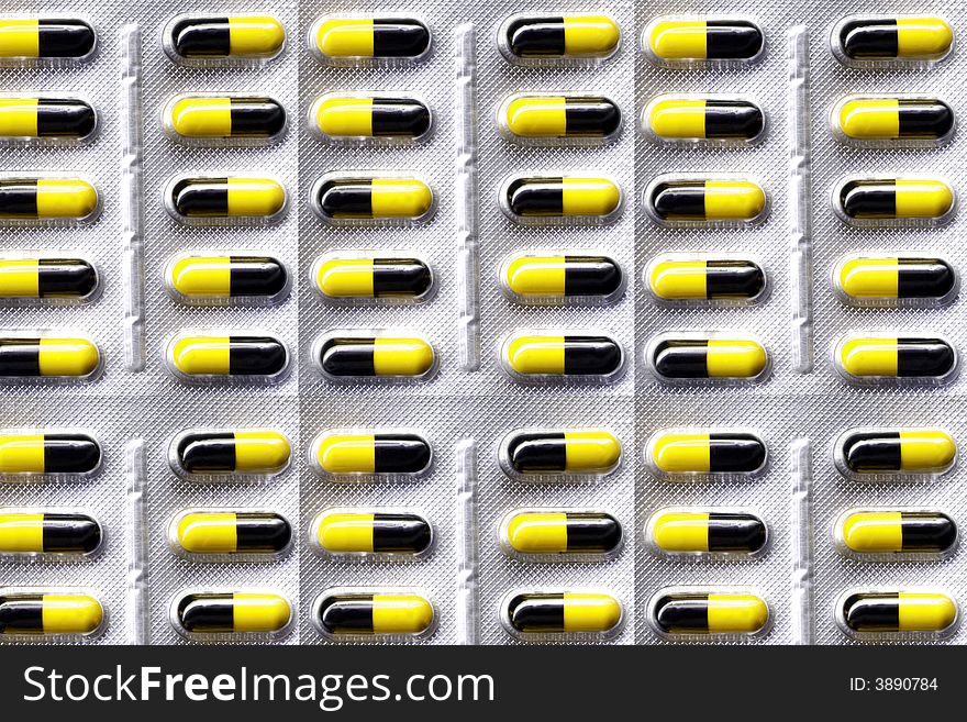 Yellow and black medical pills