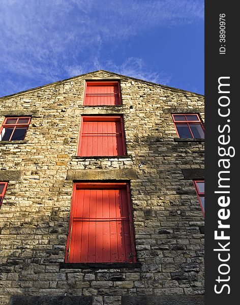 Three red doors on the gable end of a brewery. Three red doors on the gable end of a brewery