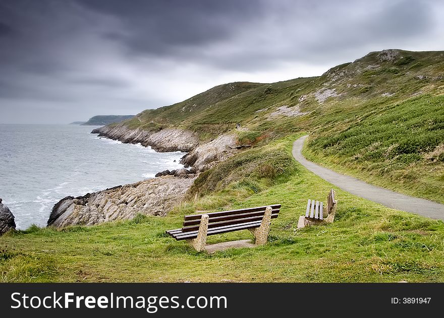 Two benches looking over the ocean. Two benches looking over the ocean