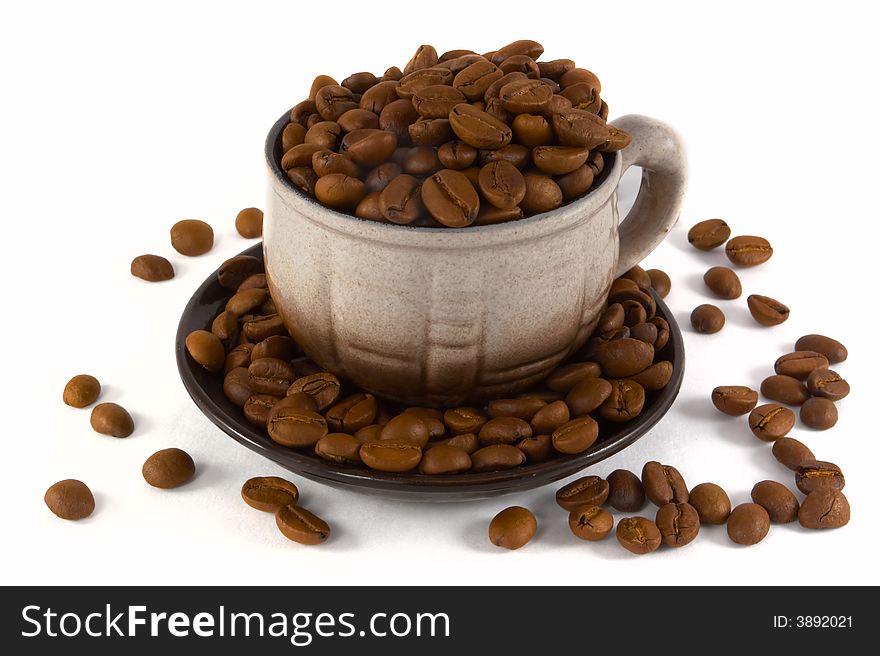 Coffee beans in the cup on white background