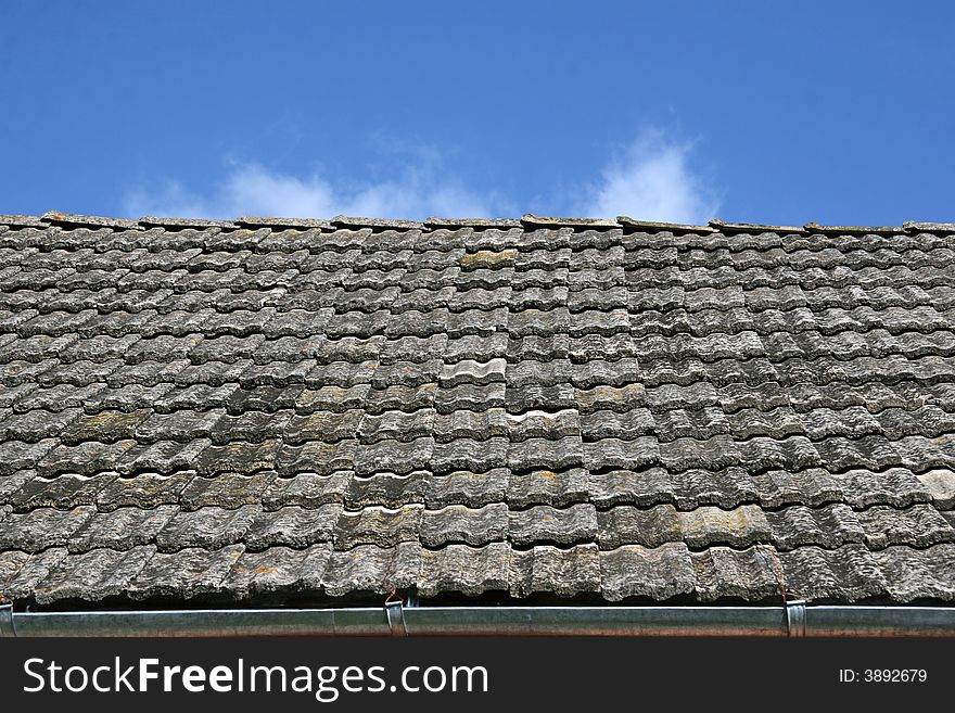 Roof tiled on a background of the dark blue sky