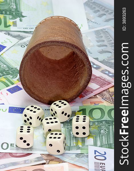 Dice shaker with dices on Euro notes. Dice shaker with dices on Euro notes