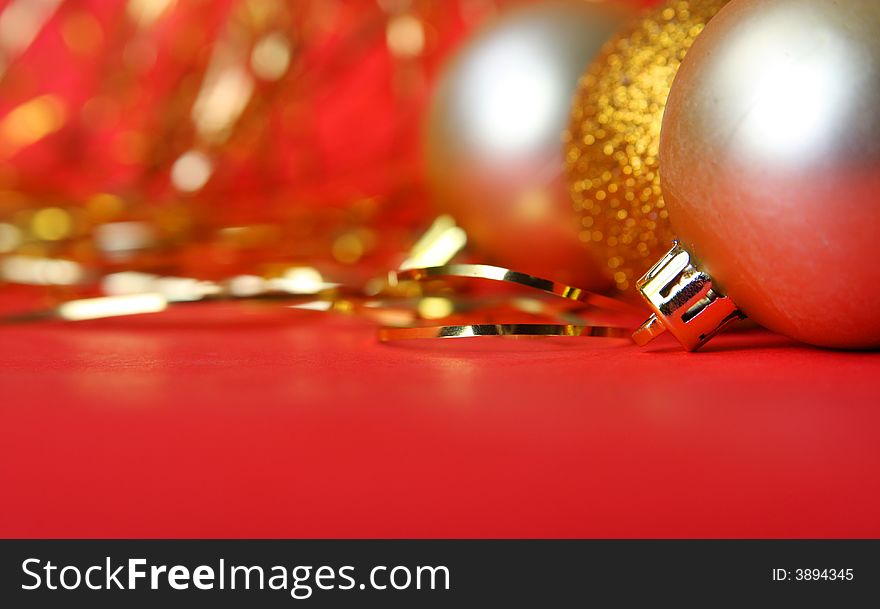 Christmas ornament, gold balls and red background