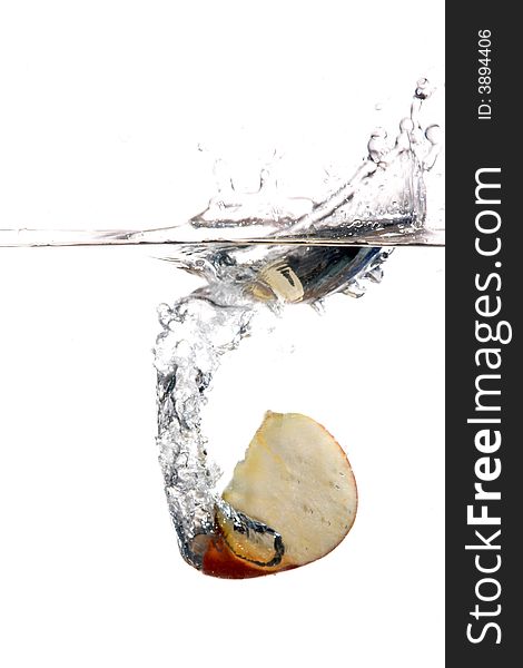 An image of slice of apple in water. An image of slice of apple in water