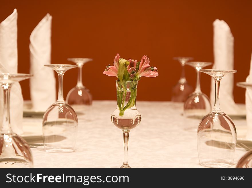 Utensils - wine-glasses and plates on a table at restaurant