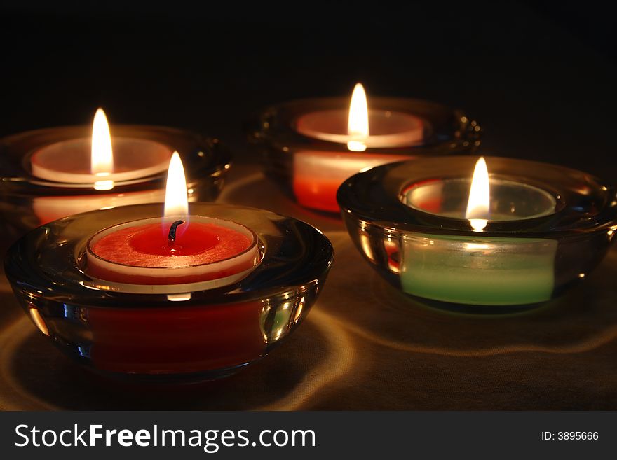 Four candles over a tablecloth