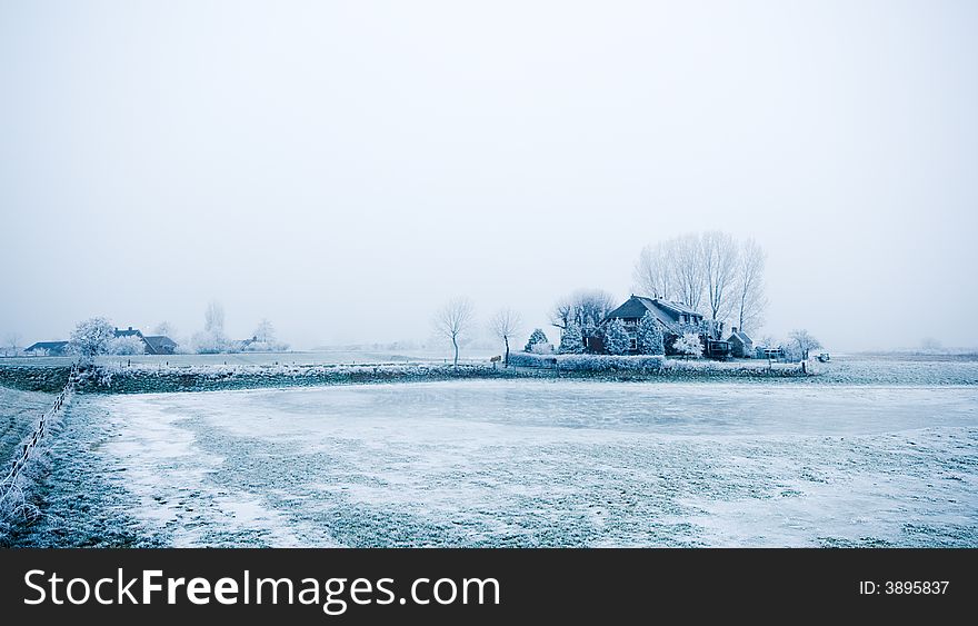 Farm house in the middle of winter surrounded by frozen trees and ice. Farm house in the middle of winter surrounded by frozen trees and ice