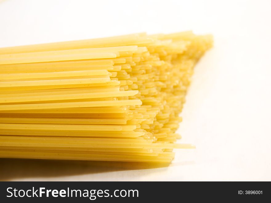 Uncooked spaghetti isolated over white background photographed, 
and  Selective Focus. Uncooked spaghetti isolated over white background photographed, 
and  Selective Focus