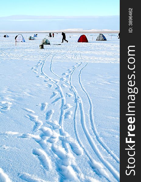 Fishing on an ice of the frozen lake. Fishing on an ice of the frozen lake