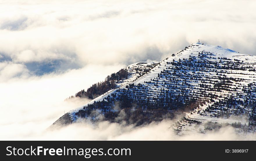 Mountains above the clouds in winter near the ski resort of alpes d'huez in france