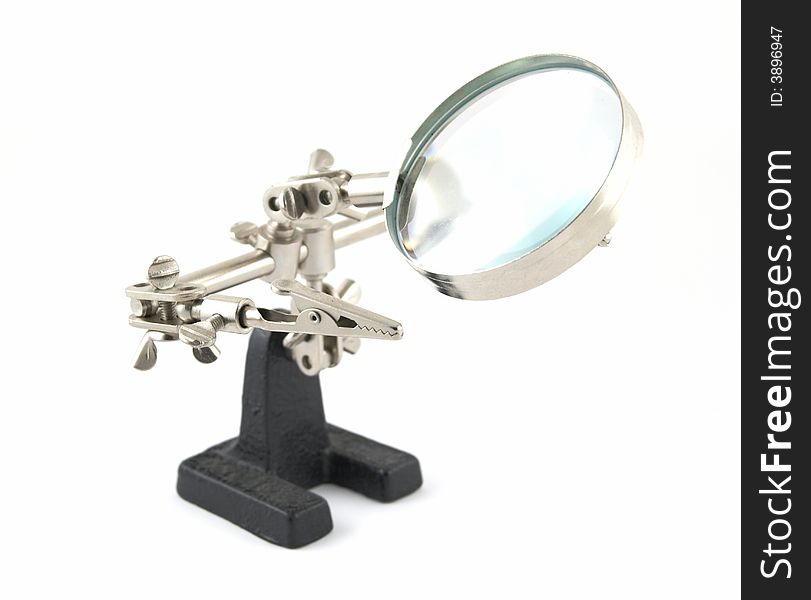 Clip devices and magnifier on white background. Clip devices and magnifier on white background