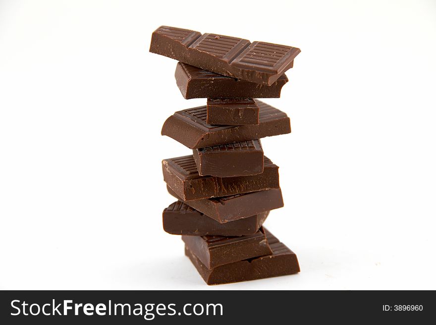 Slices of bitter chocolate on white background