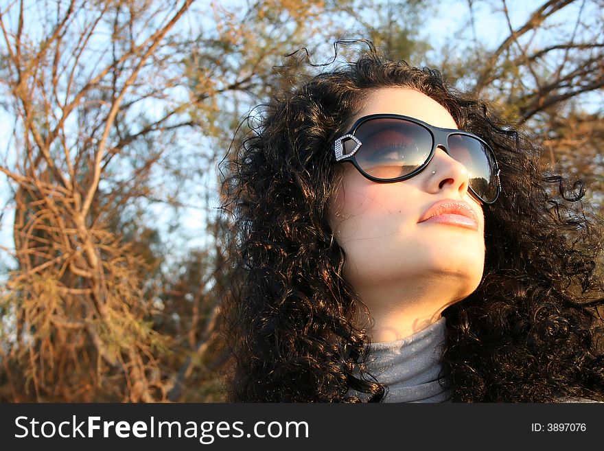 A beautiful young brunette model with sunglasses. A beautiful young brunette model with sunglasses