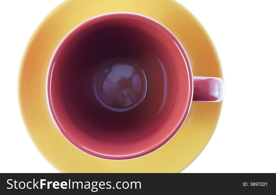 Color cup a view with top. A dark red cup and yellow dish